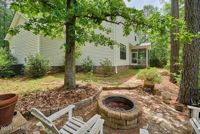11 Bedford Cir, Pinehurst, NC 28374 - view of patio / terrace featuring a fire pit, a sunroom, and central air condition unit