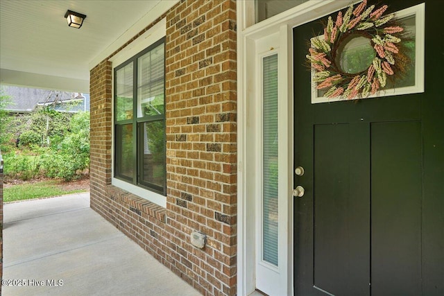 11 Bedford Cir, Pinehurst, NC 28374 - view of exterior entry featuring brick siding and covered porch