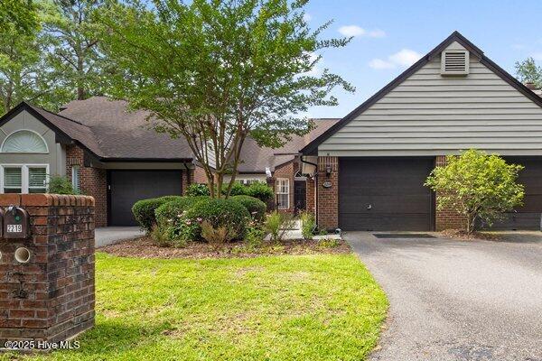 2219 Jumpin Run Dr, Wilmington, NC 28403 - single story home featuring asphalt driveway, brick siding, and a garage