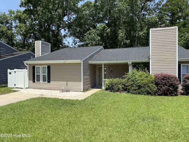 2414 Educational Dr, New Bern, NC 28562 - view of front of property with a chimney, a front lawn, and a shingled roof