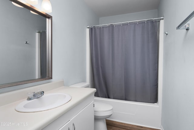 2414 Educational Dr, New Bern, NC 28562 - full bathroom with toilet, vanity, wood finished floors, and shower / bathtub combination with curtain