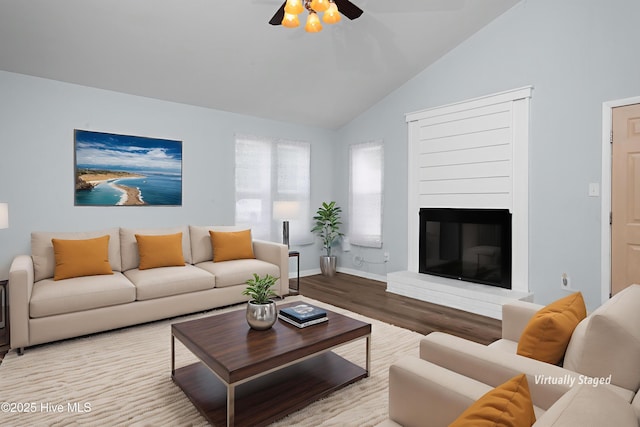 2414 Educational Dr, New Bern, NC 28562 - living area featuring wood finished floors, a ceiling fan, a glass covered fireplace, baseboards, and high vaulted ceiling