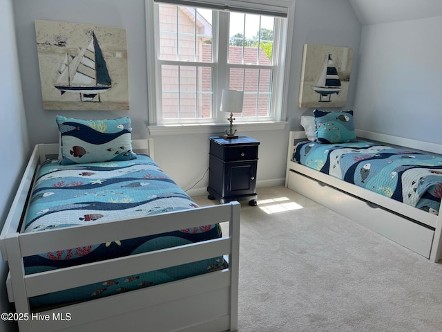 bedroom with carpet, vaulted ceiling, and baseboards