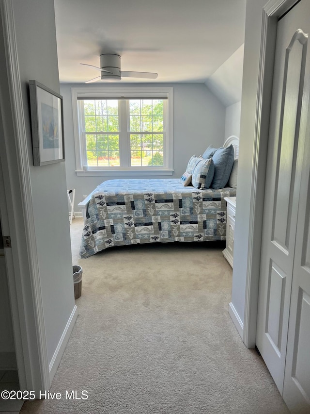 bedroom featuring carpet flooring, baseboards, and vaulted ceiling