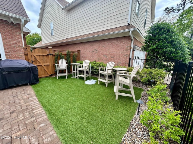 view of yard featuring a gate and an attached garage