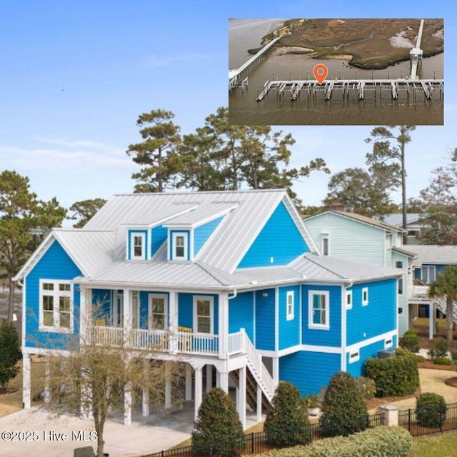 114 Lucas Cv, Oak Island, NC 28465 - coastal inspired home featuring covered porch, metal roof, stairway, and a carport