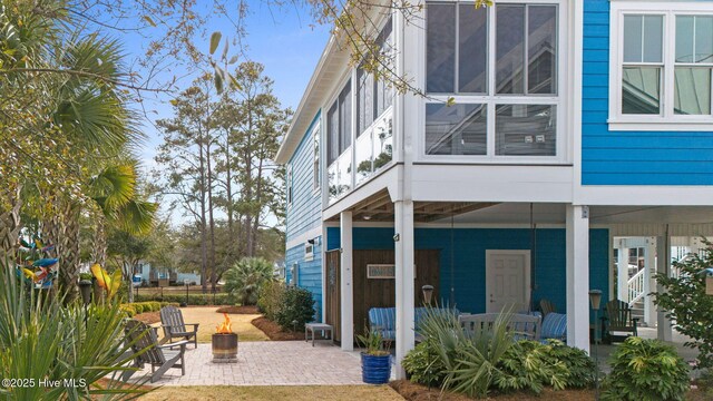 114 Lucas Cv, Oak Island, NC 28465 - back of house with a patio area