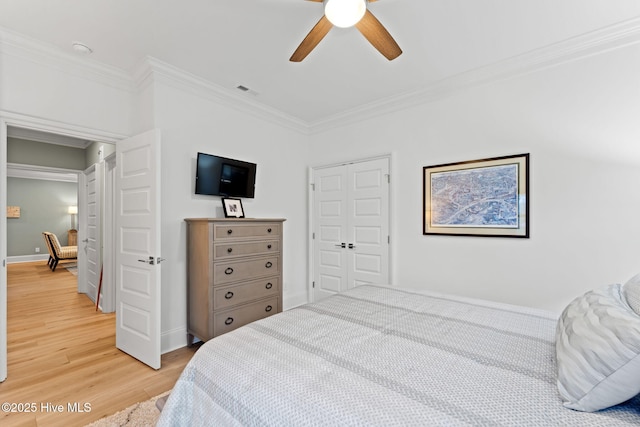 114 Lucas Cv, Oak Island, NC 28465 - bedroom with crown molding, light wood finished floors, a ceiling fan, a closet, and baseboards