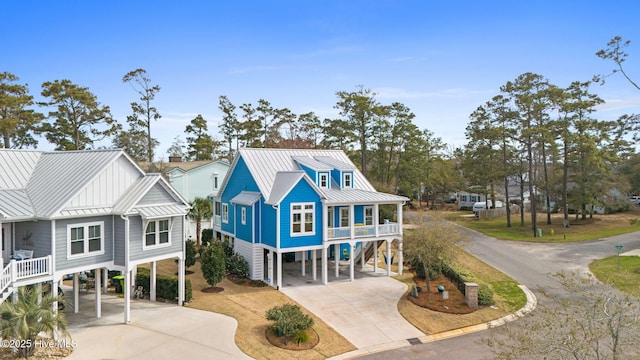 114 Lucas Cv, Oak Island, NC 28465 - view of front of property featuring a carport, stairs, and driveway
