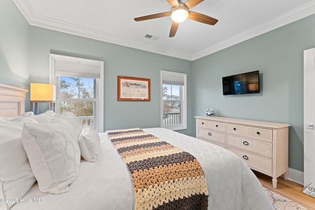 114 Lucas Cv, Oak Island, NC 28465 - bedroom featuring crown molding, light wood finished floors, and a ceiling fan