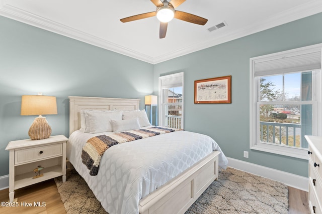 114 Lucas Cv, Oak Island, NC 28465 - bedroom featuring crown molding, wood finished floors, baseboards, and a ceiling fan