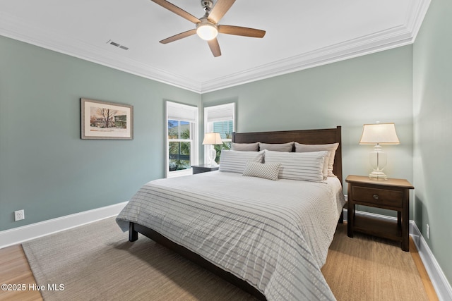 114 Lucas Cv, Oak Island, NC 28465 - bedroom featuring ornamental molding, baseboards, light wood-style flooring, and a ceiling fan