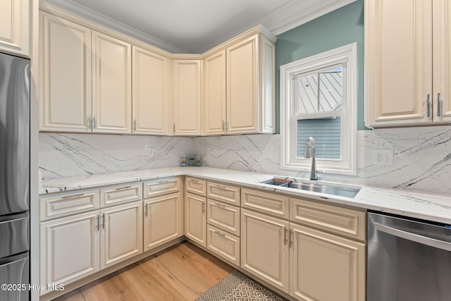 114 Lucas Cv, Oak Island, NC 28465 - kitchen featuring cream cabinets, stainless steel appliances, a sink, and backsplash