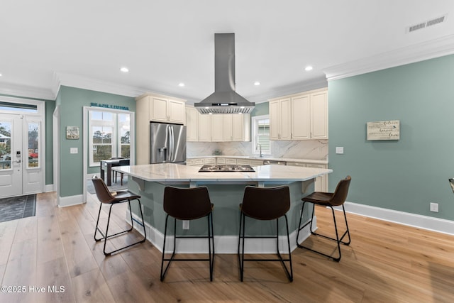 114 Lucas Cv, Oak Island, NC 28465 - kitchen with island exhaust hood, stainless steel appliances, ornamental molding, a center island, and baseboards
