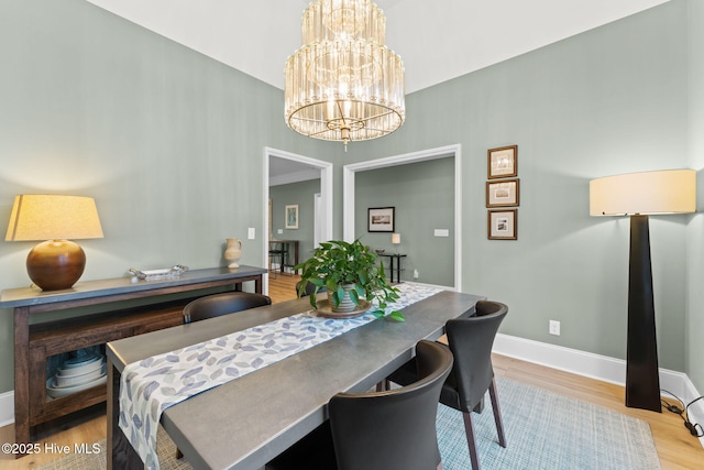 114 Lucas Cv, Oak Island, NC 28465 - dining room with a chandelier, wood finished floors, and baseboards