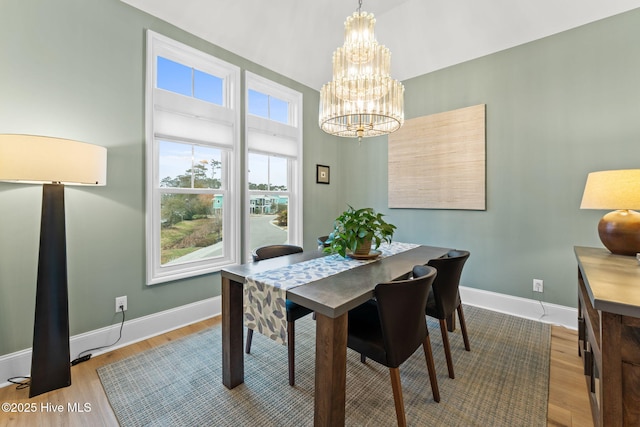 114 Lucas Cv, Oak Island, NC 28465 - dining area featuring a chandelier, wood finished floors, and baseboards