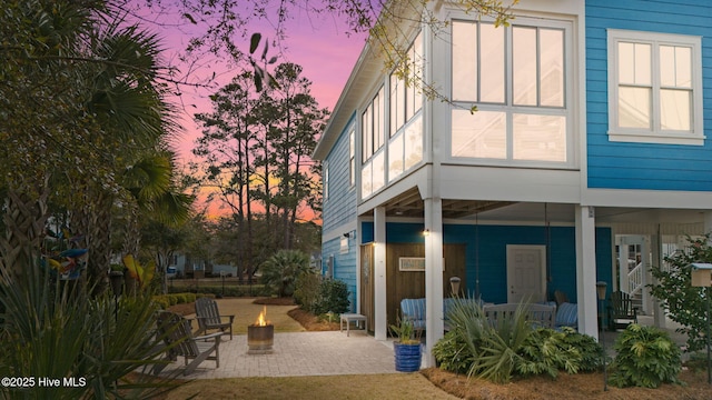 114 Lucas Cv, Oak Island, NC 28465 - back of house featuring a patio area and an outdoor fire pit