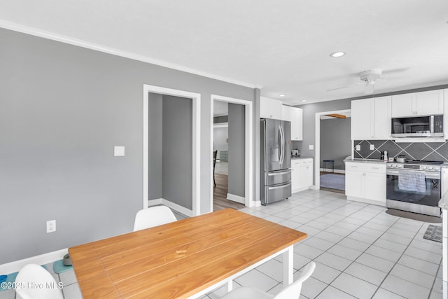 320 Embassy Cir, Wilmington, NC 28412 - kitchen featuring stainless steel appliances, tasteful backsplash, white cabinets, recessed lighting, and ornamental molding