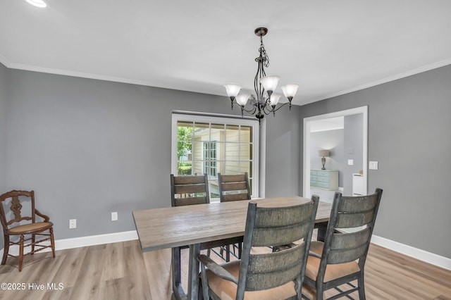 320 Embassy Cir, Wilmington, NC 28412 - dining area featuring a chandelier, light wood finished floors, and ornamental molding