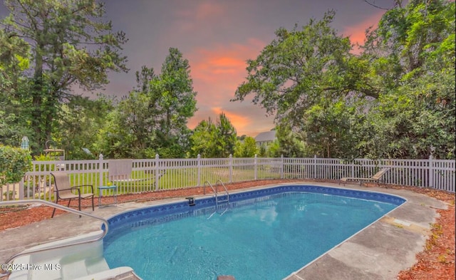 320 Embassy Cir, Wilmington, NC 28412 - pool at dusk featuring a fenced backyard and view of scattered trees