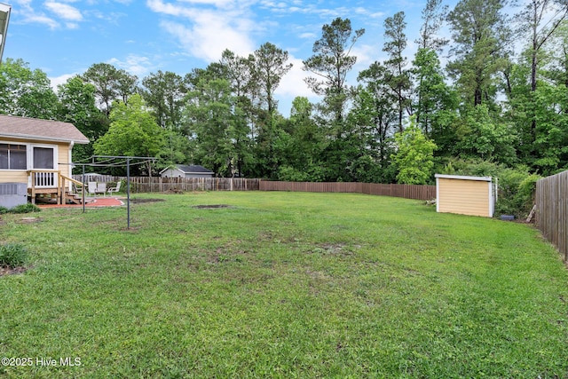 view of yard with a storage unit, an outdoor structure, and view of scattered trees