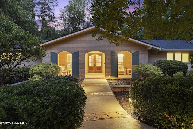 221 Quail Ridge Rd, Wilmington, NC 28409 - single story home featuring brick siding, french doors, and covered porch