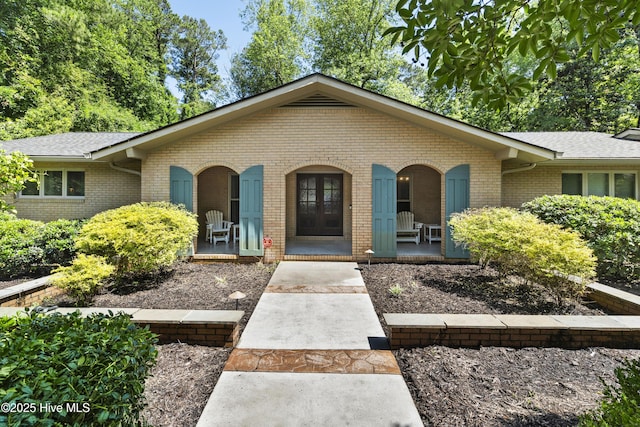 221 Quail Ridge Rd, Wilmington, NC 28409 - ranch-style home featuring a porch, brick siding, and roof with shingles