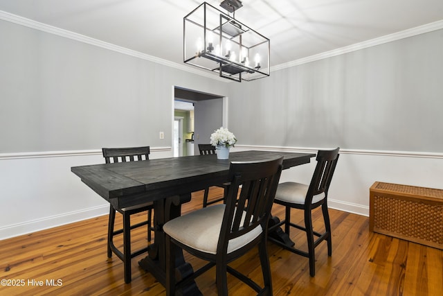 221 Quail Ridge Rd, Wilmington, NC 28409 - dining room with a chandelier, ornamental molding, baseboards, hardwood / wood-style flooring, and radiator