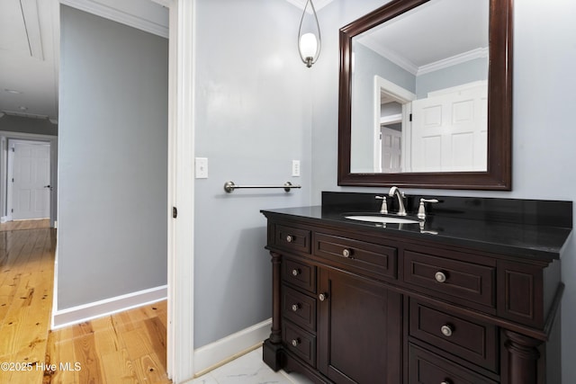 221 Quail Ridge Rd, Wilmington, NC 28409 - bathroom with ornamental molding, baseboards, vanity, and wood finished floors