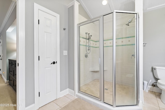 221 Quail Ridge Rd, Wilmington, NC 28409 - bathroom featuring a shower stall, toilet, tile patterned flooring, and baseboards