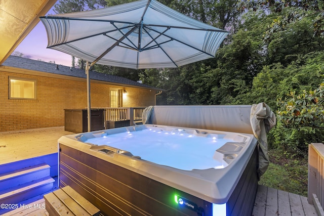 221 Quail Ridge Rd, Wilmington, NC 28409 - deck at dusk featuring a hot tub