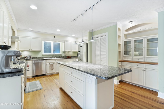 221 Quail Ridge Rd, Wilmington, NC 28409 - kitchen featuring appliances with stainless steel finishes, ornamental molding, light wood-type flooring, white cabinetry, and recessed lighting