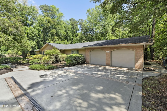 221 Quail Ridge Rd, Wilmington, NC 28409 - view of front of house with a garage, brick siding, and concrete driveway