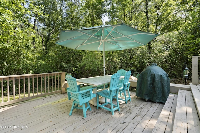 221 Quail Ridge Rd, Wilmington, NC 28409 - wooden deck featuring outdoor dining space, view of wooded area, and grilling area
