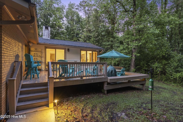 221 Quail Ridge Rd, Wilmington, NC 28409 - back of property featuring a chimney, a wooden deck, and view of wooded area