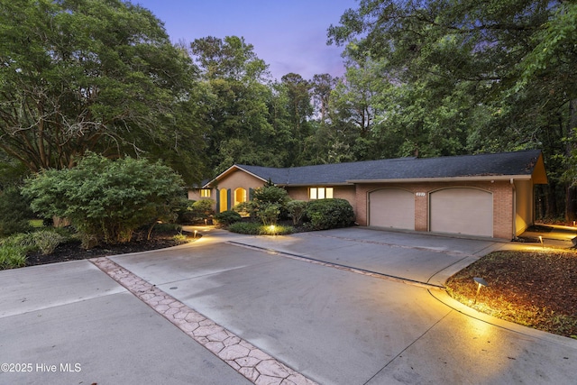 221 Quail Ridge Rd, Wilmington, NC 28409 - single story home with driveway, an attached garage, and brick siding