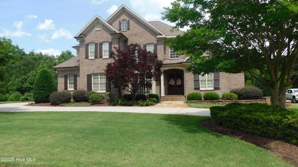 2712 Isaac Dr, Goldsboro, NC 27530 - view of front facade with brick siding and a front yard