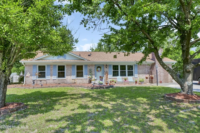 5325 Lord Tennyson Rd, Wilmington, NC 28405 - ranch-style home with brick siding and a front yard