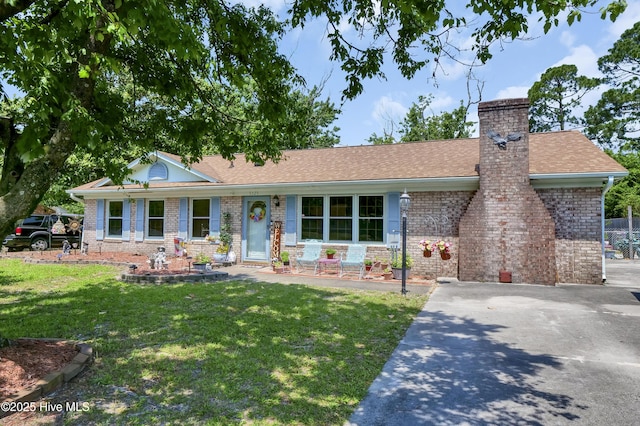 5325 Lord Tennyson Rd, Wilmington, NC 28405 - ranch-style home featuring a front yard, brick siding, a chimney, and a shingled roof