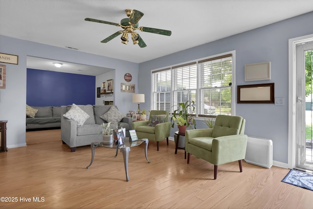 5325 Lord Tennyson Rd, Wilmington, NC 28405 - living room featuring light wood-style floors, ceiling fan, and baseboards