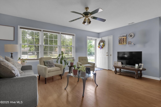 5325 Lord Tennyson Rd, Wilmington, NC 28405 - living area with wood finished floors, a ceiling fan, and baseboards