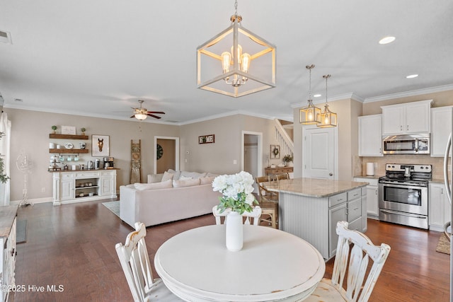 433 Landsdowne Cir, Hampstead, NC 28443 - dining room featuring dark wood-style floors, a ceiling fan, recessed lighting, a chandelier, and crown molding