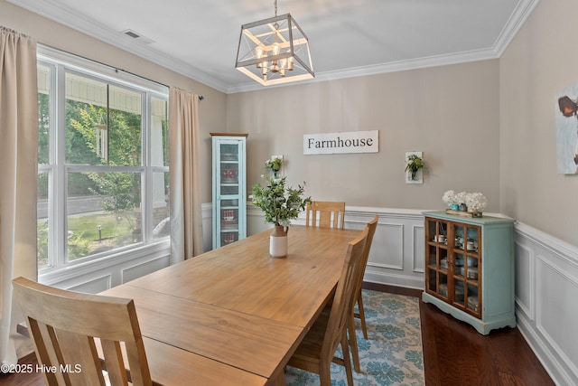 433 Landsdowne Cir, Hampstead, NC 28443 - dining area featuring a chandelier, healthy amount of natural light, dark wood-style flooring, ornamental molding, and a decorative wall