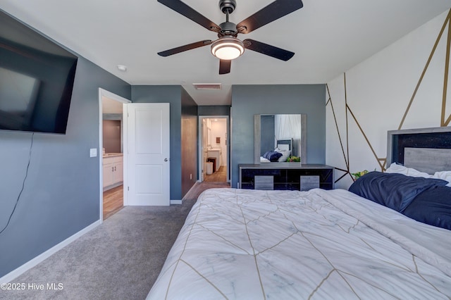 1145 Saint Augustine Dr, Castle Hayne, NC 28429 - carpeted bedroom with baseboards, a ceiling fan, and ensuite bathroom