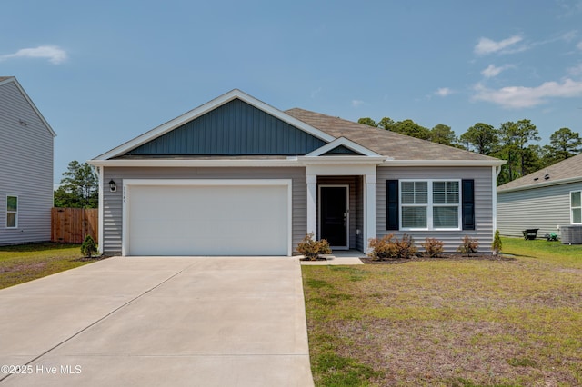 1145 Saint Augustine Dr, Castle Hayne, NC 28429 - view of front of house featuring concrete driveway, a garage, board and batten siding, and central AC