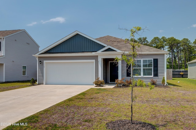 1145 Saint Augustine Dr, Castle Hayne, NC 28429 - view of front of property featuring an attached garage, concrete driveway, and board and batten siding