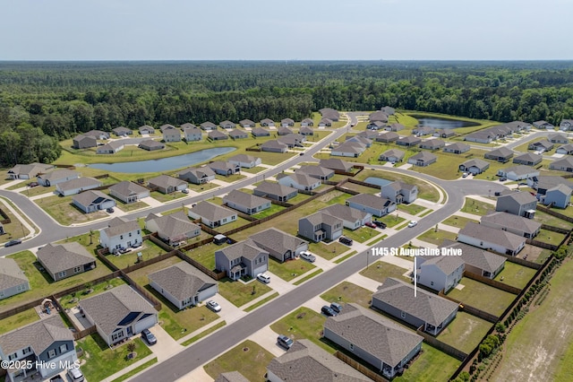 1145 Saint Augustine Dr, Castle Hayne, NC 28429 - aerial view of property and surrounding area with a forest, a large body of water, and nearby suburban area