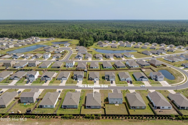 1145 Saint Augustine Dr, Castle Hayne, NC 28429 - aerial view of residential area featuring a heavily wooded area and a nearby body of water