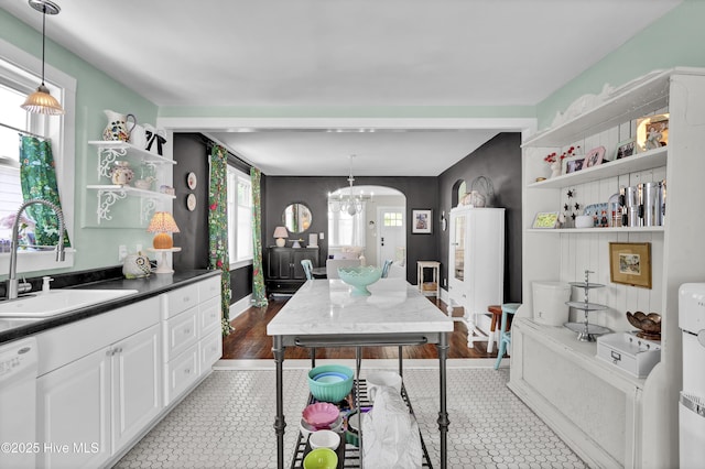 416 S 8th St, Wilmington, NC 28401 - kitchen with open shelves, a sink, a chandelier, dishwasher, and white cabinetry