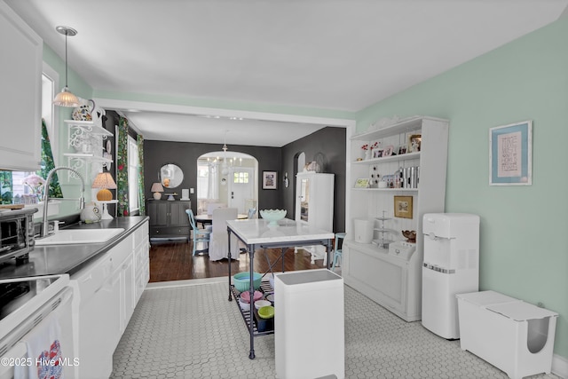 416 S 8th St, Wilmington, NC 28401 - kitchen with a sink, arched walkways, water heater, open shelves, and white cabinets